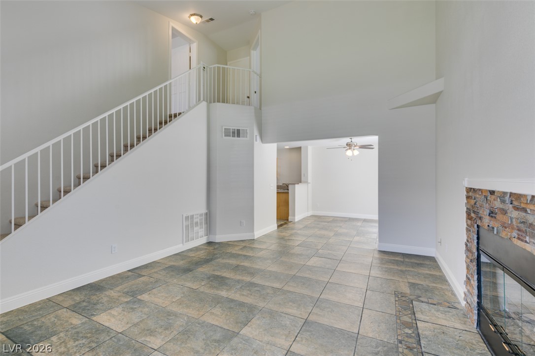 200 Luninborg Street Henderson, NV 89074 - Photo 22 of 40 A spacious common area boasts stone-look tile flooring and a stacked stone fireplace.