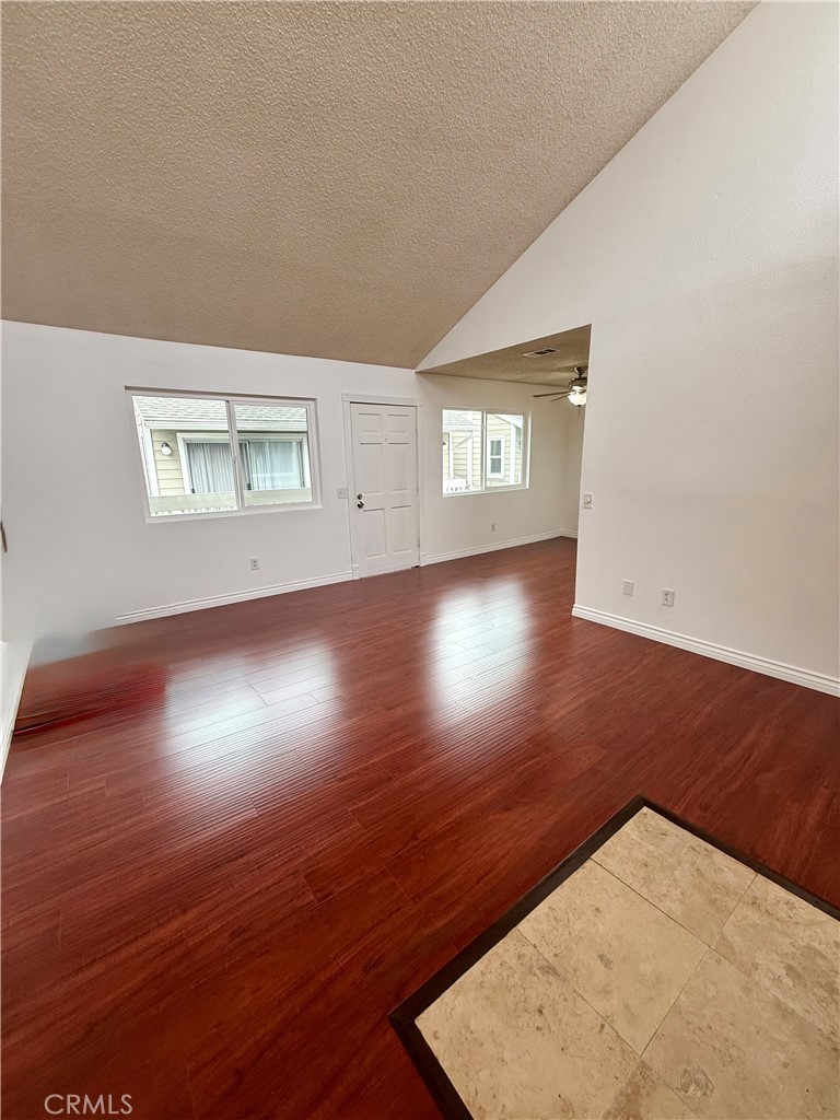 10700 Colima Road, Unit 914 Whittier, CA 90604 - Photo 10 of 14 an empty room with wooden floor and windows