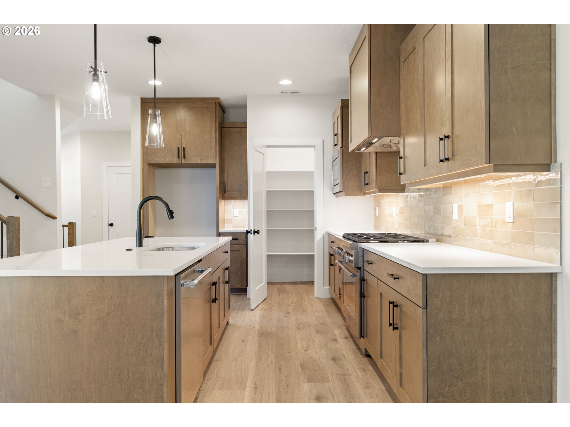 2947 Northwest 114th Terrace Portland, OR 97229 - Photo 12 of 46 a kitchen with kitchen island a sink stove and refrigerator