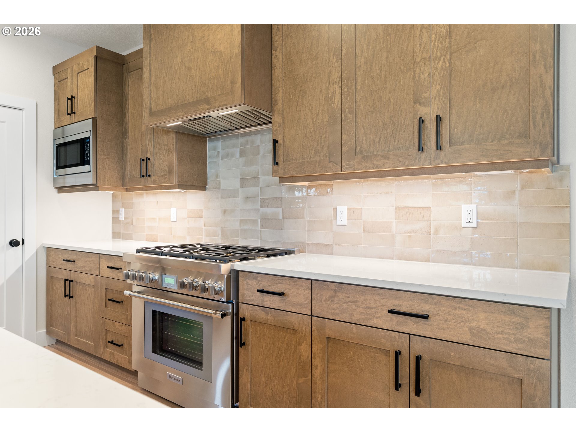 2947 Northwest 114th Terrace Portland, OR 97229 - Photo 15 of 46 a kitchen with stainless steel appliances granite countertop a stove a sink and a microwave