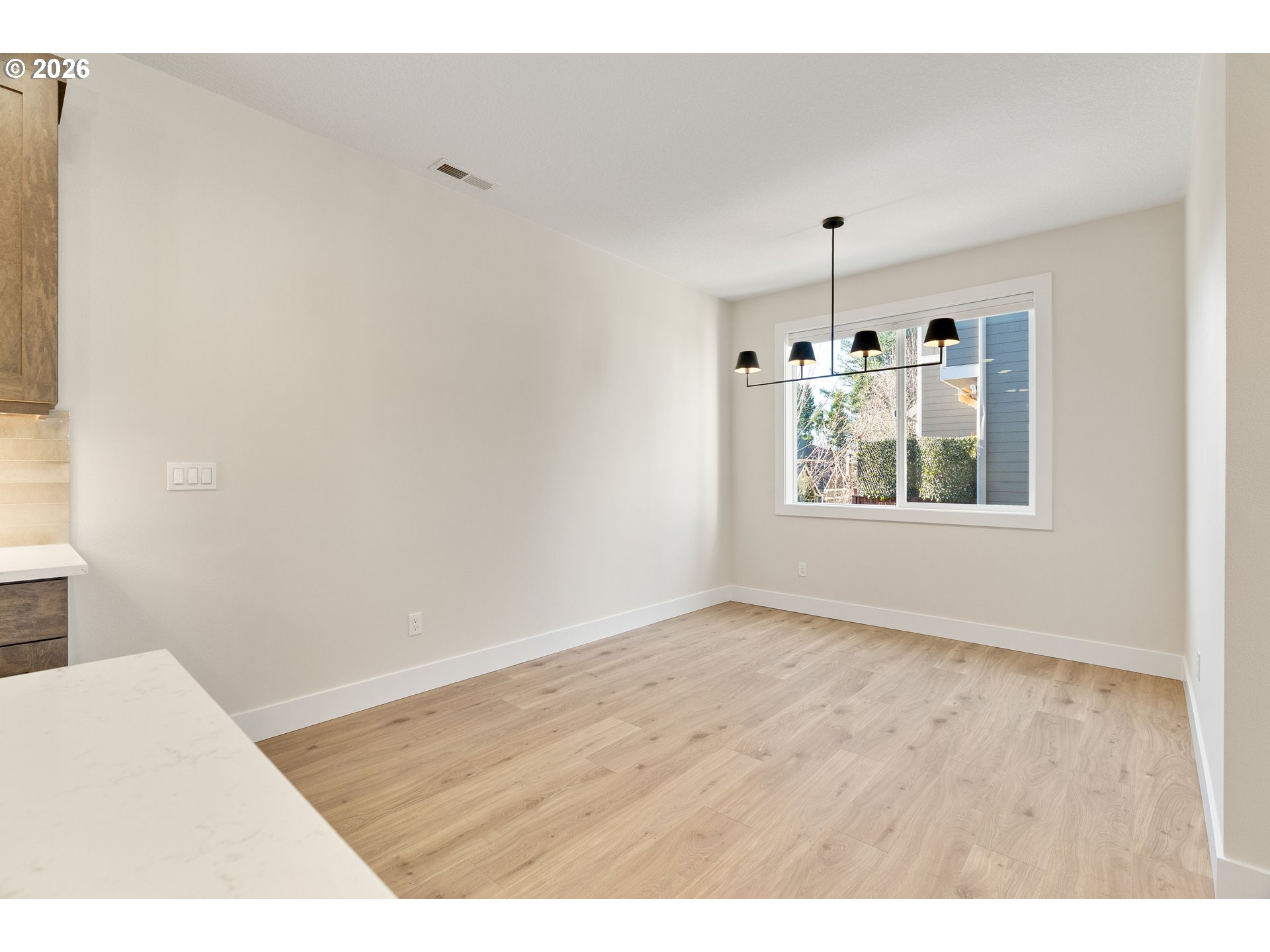 2947 Northwest 114th Terrace Portland, OR 97229 - Photo 16 of 46 a view of an empty room with window and wooden floor