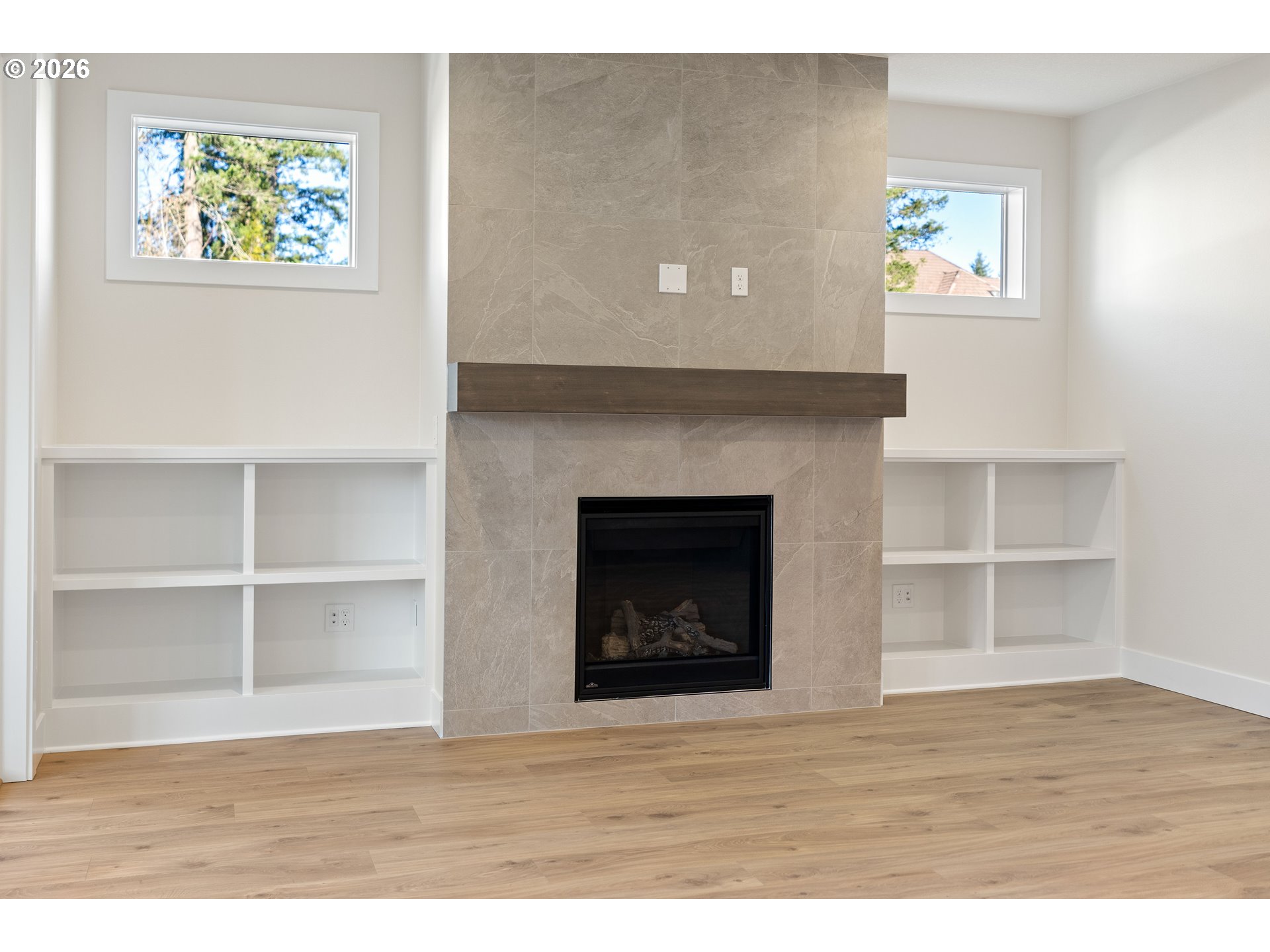 2947 Northwest 114th Terrace Portland, OR 97229 - Photo 19 of 46 a room with a fireplace and a painting on the wall