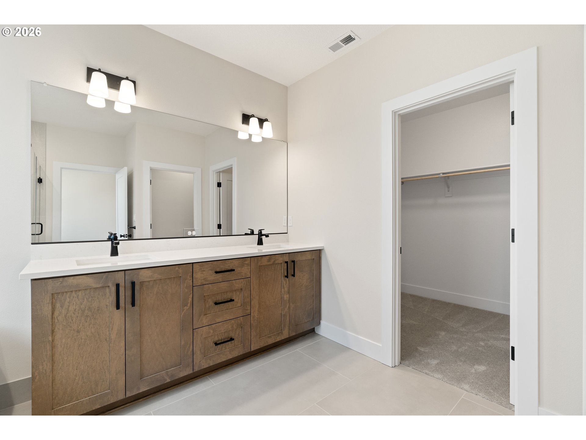 2947 Northwest 114th Terrace Portland, OR 97229 - Photo 26 of 46 a spacious bathroom with a double vanity sink a mirror and a