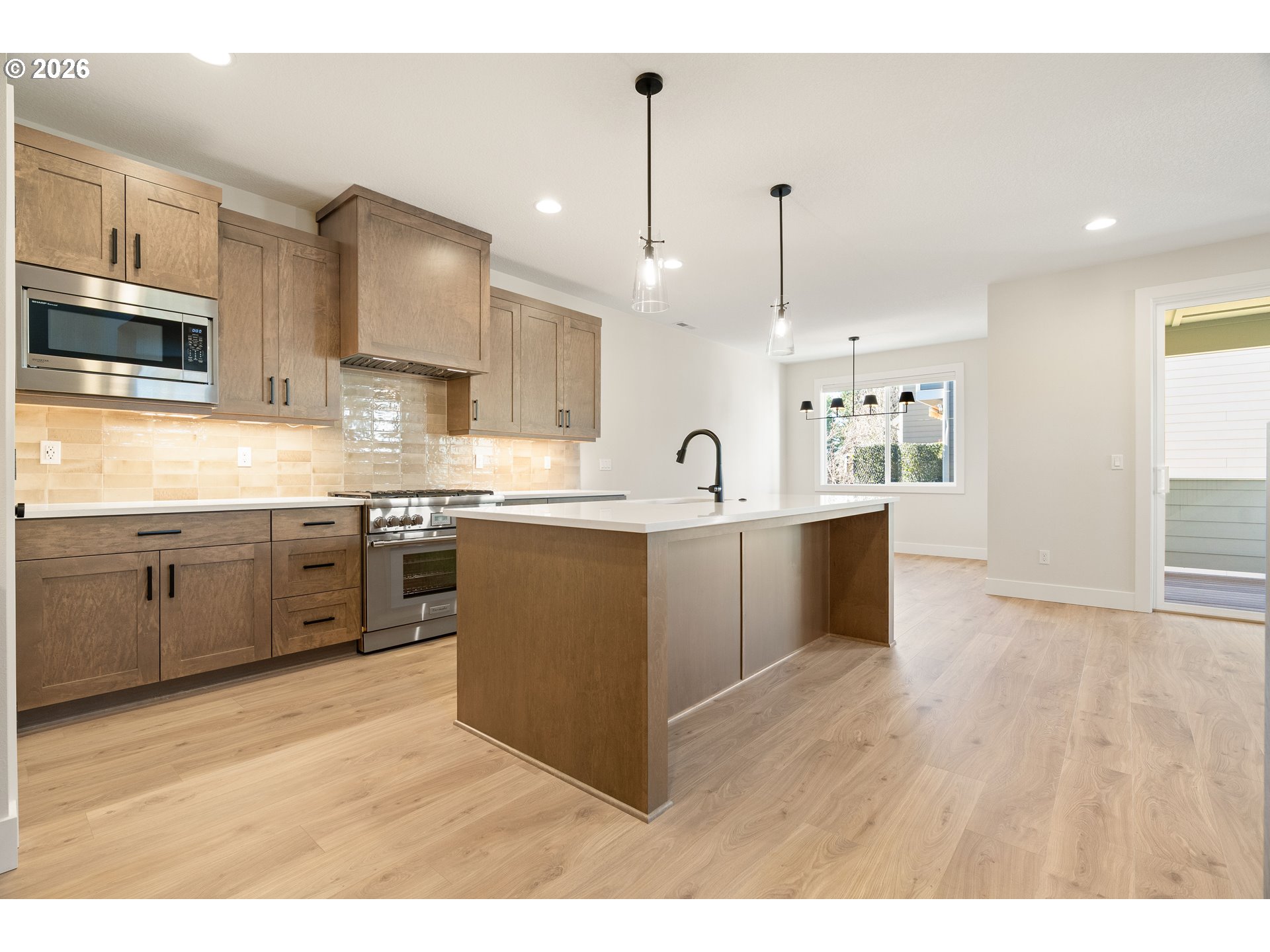 2947 Northwest 114th Terrace Portland, OR 97229 - Photo 7 of 46 a kitchen with stainless steel appliances kitchen island a sink refrigerator and cabinets