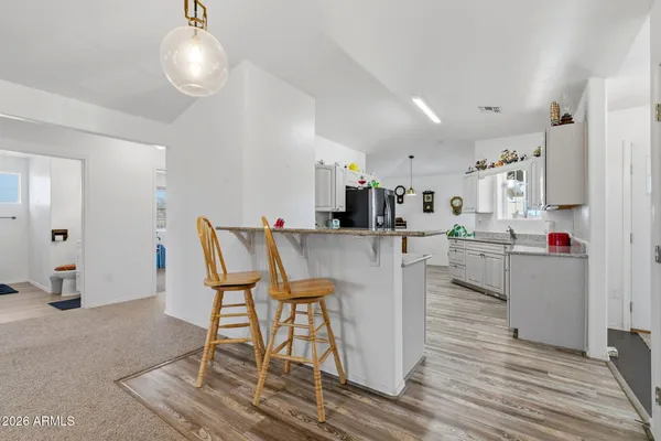 a living room with kitchen island furniture and a chandelier