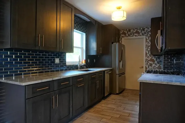 a view of kitchen with cabinets and wooden floor