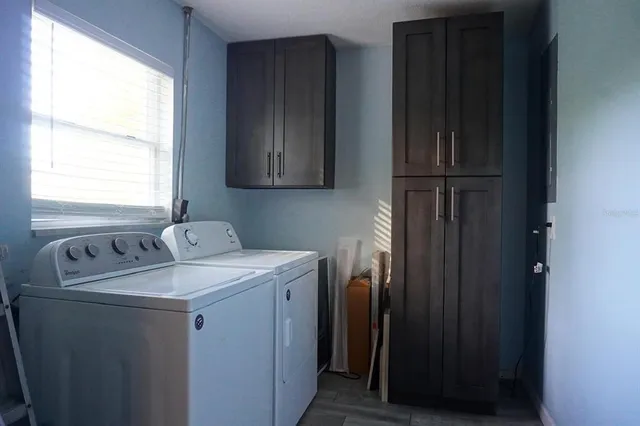 an empty room with a window and wooden floor