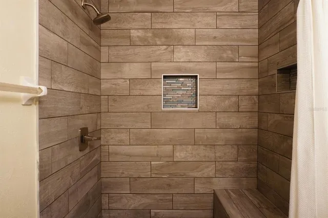 a bathroom with a granite countertop bathtub sink vanity mirror and toilet