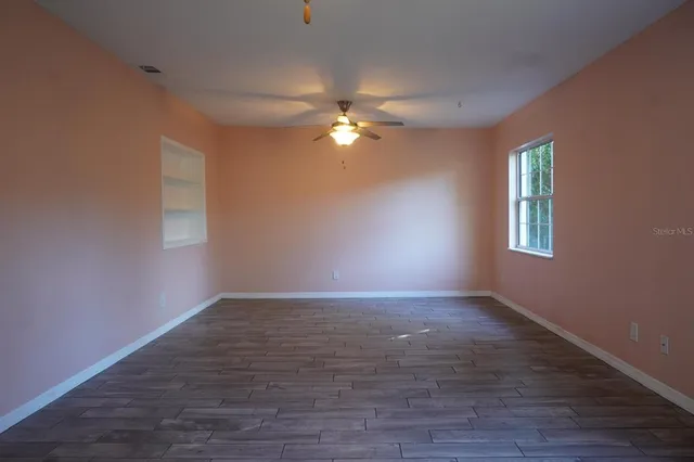 wooden floor in an empty room with a window