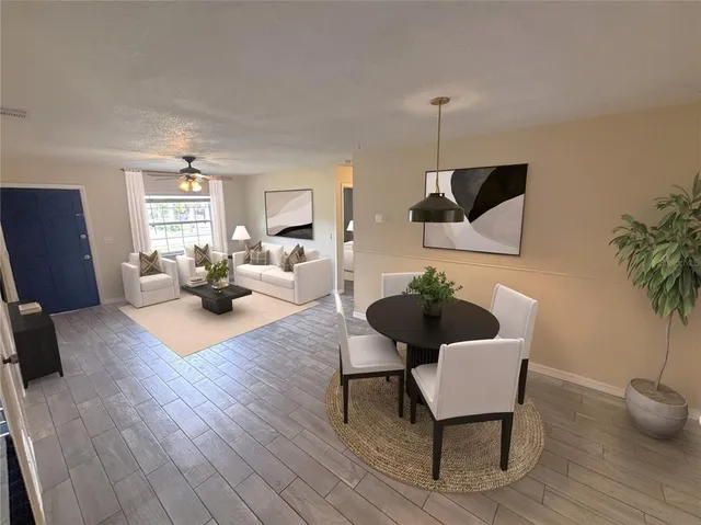 a living room with furniture and a potted plant