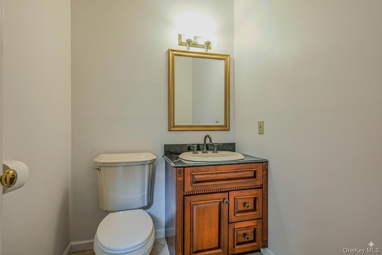 4 Skunk Hollow Road Huntington, NY 11743 - Photo 12 of 35 a bathroom with a toilet a sink and mirror