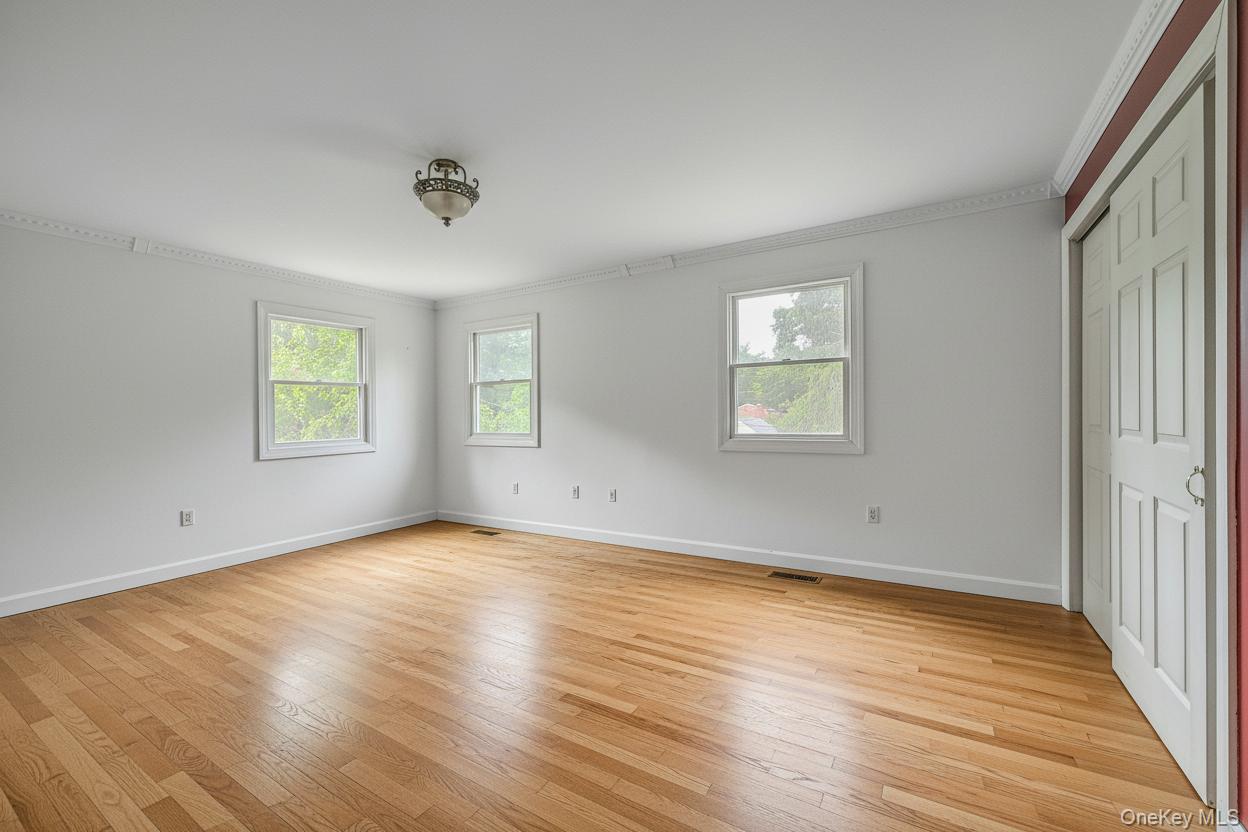 4 Skunk Hollow Road Huntington, NY 11743 - Photo 21 of 35 an empty room with wooden floor and windows