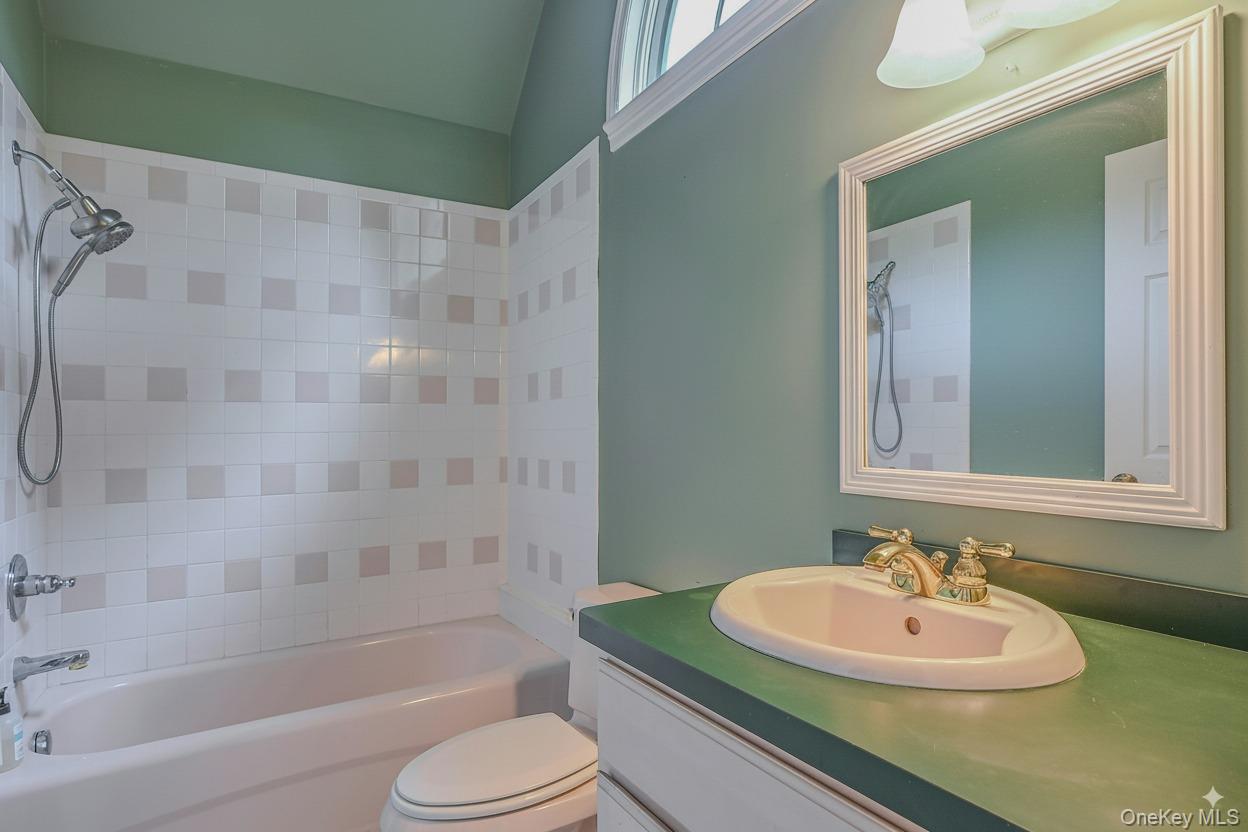 4 Skunk Hollow Road Huntington, NY 11743 - Photo 28 of 35 a bathroom with a sink a toilet and a bathtub