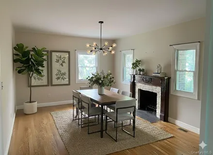 a view of a dining room with furniture and a chandelier