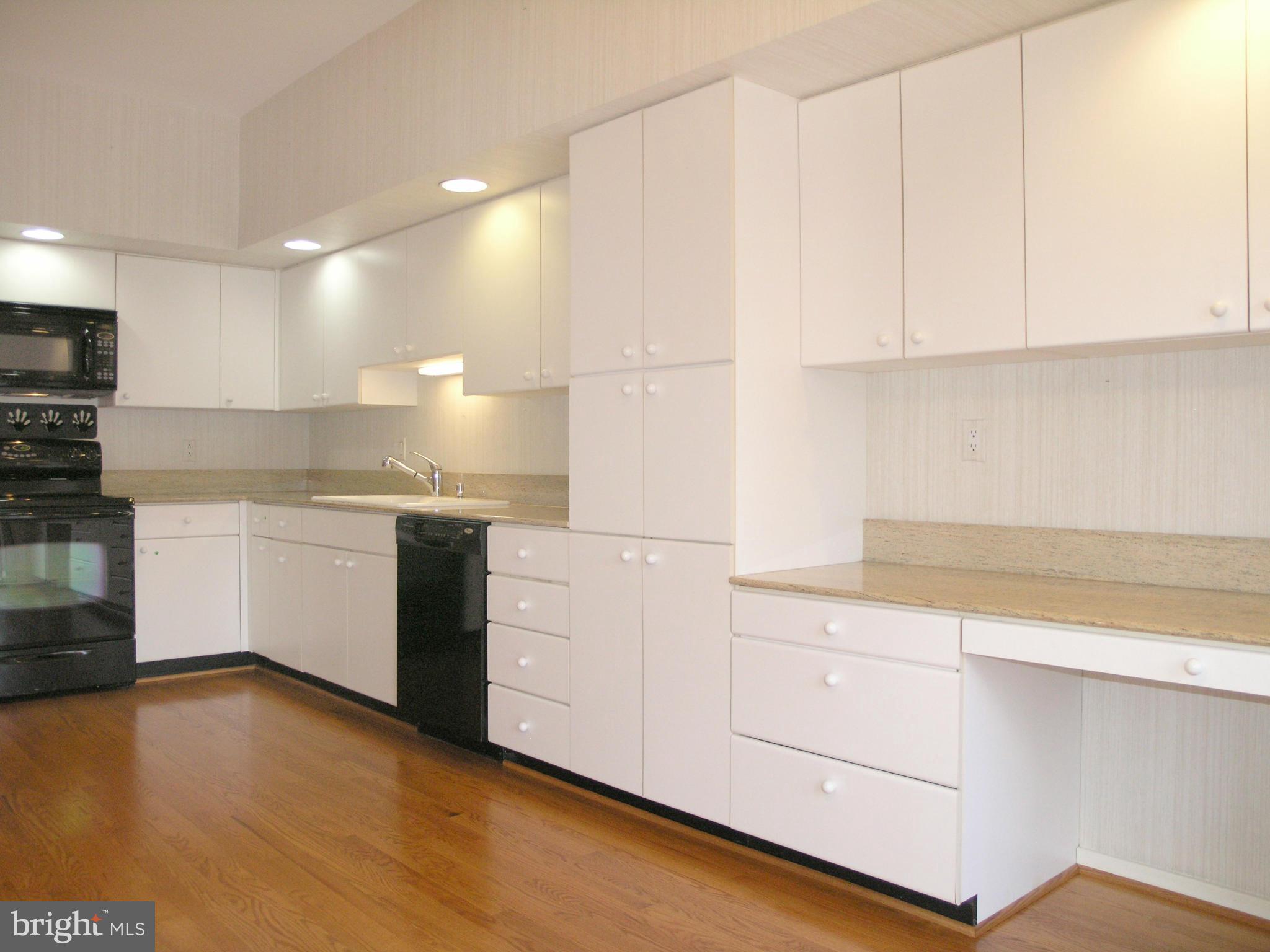 11555 Hemingway Drive Reston, VA 20194 - Photo 11 of 26 a kitchen with granite countertop white cabinets and white appliances
