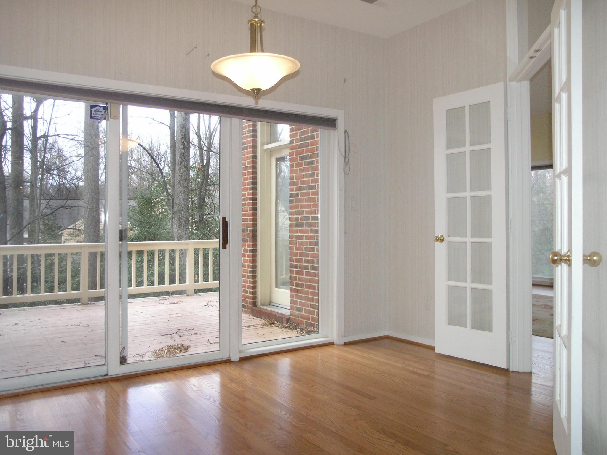 11555 Hemingway Drive Reston, VA 20194 - Photo 12 of 26 an empty room with wooden floor and windows