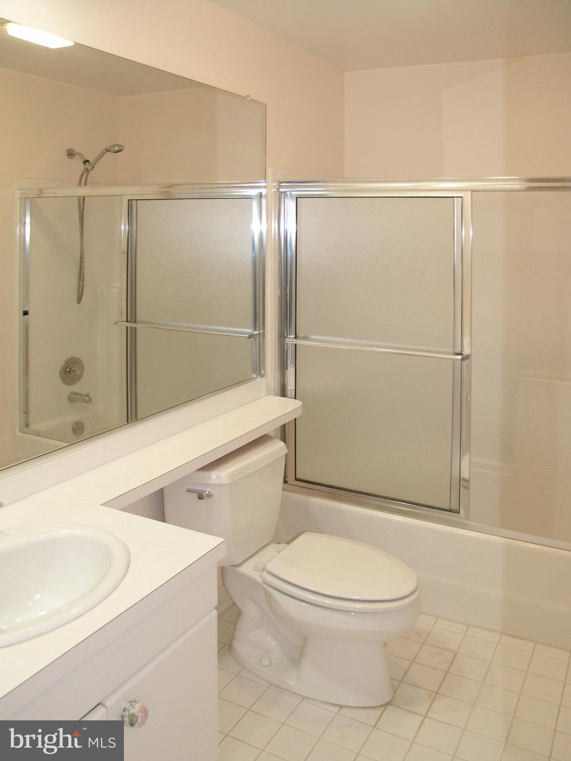 11555 Hemingway Drive Reston, VA 20194 - Photo 23 of 26 a bathroom with a toilet a sink and shower
