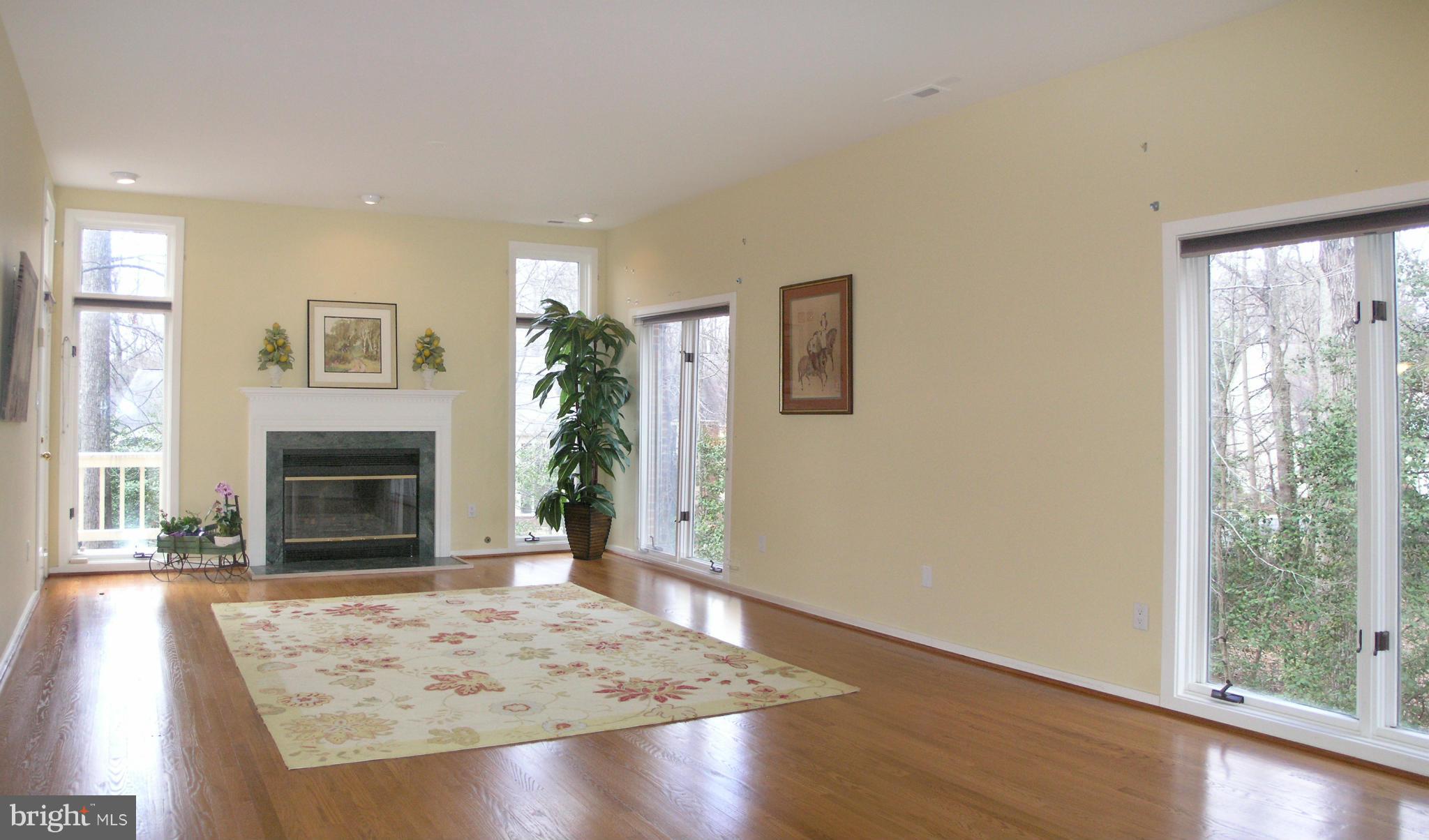 11555 Hemingway Drive Reston, VA 20194 - Photo 5 of 26 a view of a livingroom with wooden floor and a fireplace