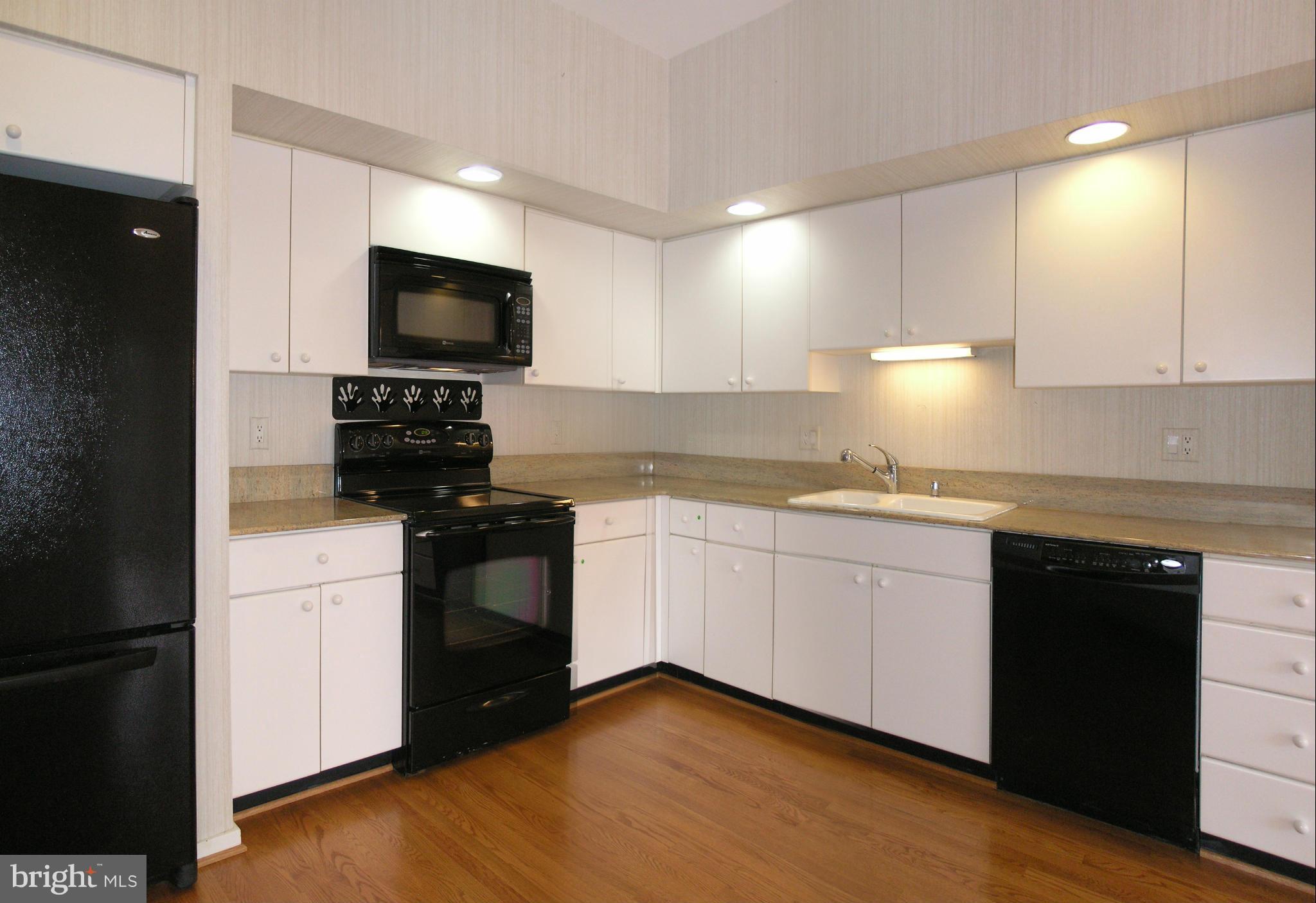 11555 Hemingway Drive Reston, VA 20194 - Photo 9 of 26 a kitchen with granite countertop white cabinets and stainless steel appliances