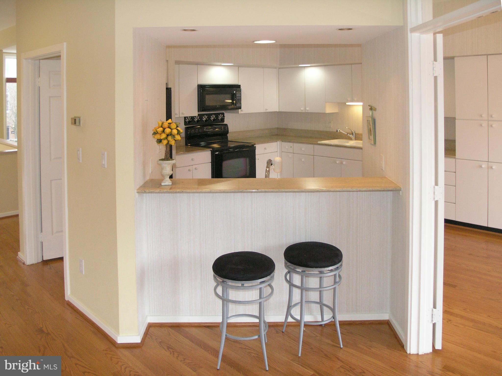 11555 Hemingway Drive Reston, VA 20194 - Photo 10 of 26 a kitchen with cabinets and chairs