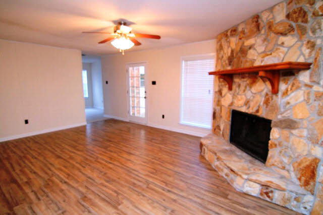 3384 Lacoste Road Mobile, AL 36618 - Photo 3 of 21 Family/Great Room with stone fireplace, new flooring and lighting. 19 x 13