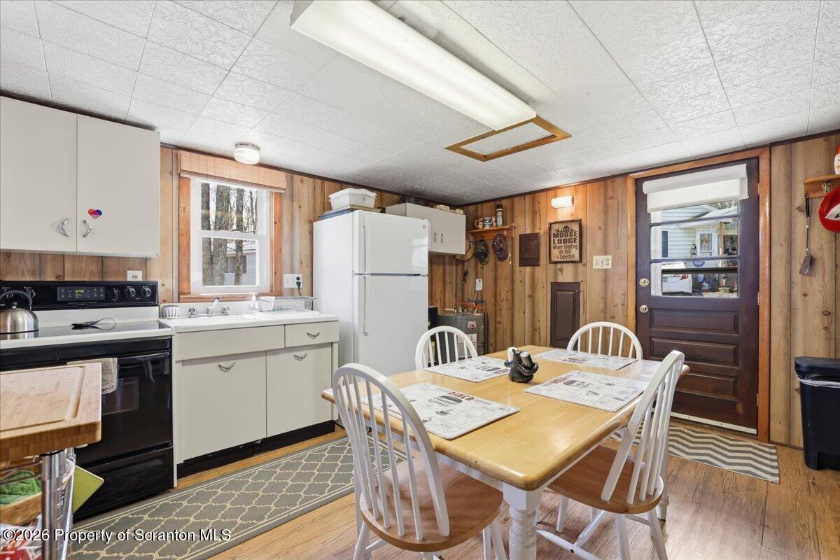 113 Stoney Hill Road Dingmans Ferry, PA 18328 - Photo 14 of 65 a dining room with stainless steel appliances granite countertop a dining table and chairs with wooden floor
