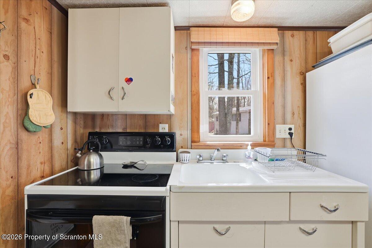 113 Stoney Hill Road Dingmans Ferry, PA 18328 - Photo 18 of 65 a kitchen with a sink a stove and a refrigerator