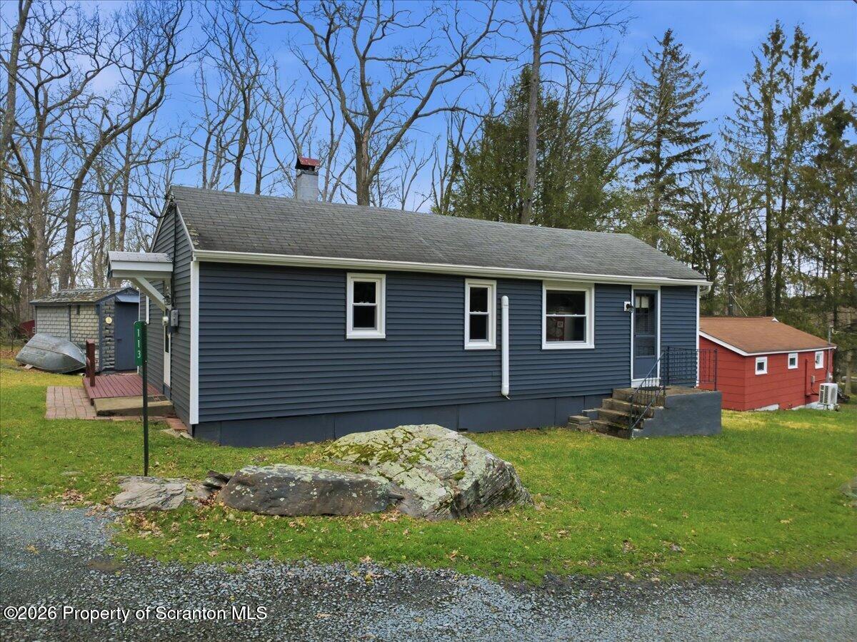 113 Stoney Hill Road Dingmans Ferry, PA 18328 - Photo 2 of 65 a front view of a house with a yard and garage