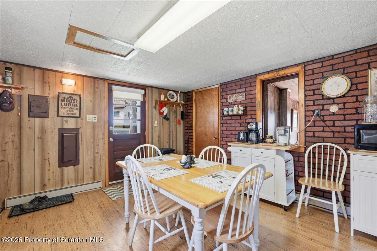 113 Stoney Hill Road Dingmans Ferry, PA 18328 - Photo 21 of 65 a view of a dining room with furniture window and wooden floor