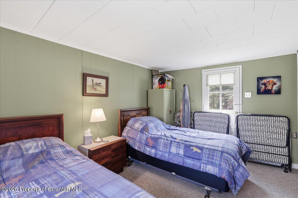 113 Stoney Hill Road Dingmans Ferry, PA 18328 - Photo 32 of 65 a bedroom with a bed and a couch