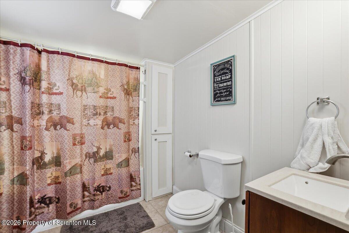 113 Stoney Hill Road Dingmans Ferry, PA 18328 - Photo 33 of 65 a white toilet sitting next to a bathroom sink