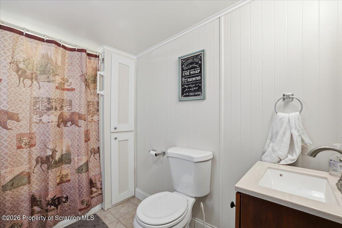 113 Stoney Hill Road Dingmans Ferry, PA 18328 - Photo 35 of 65 a white toilet sitting next to a bathroom sink