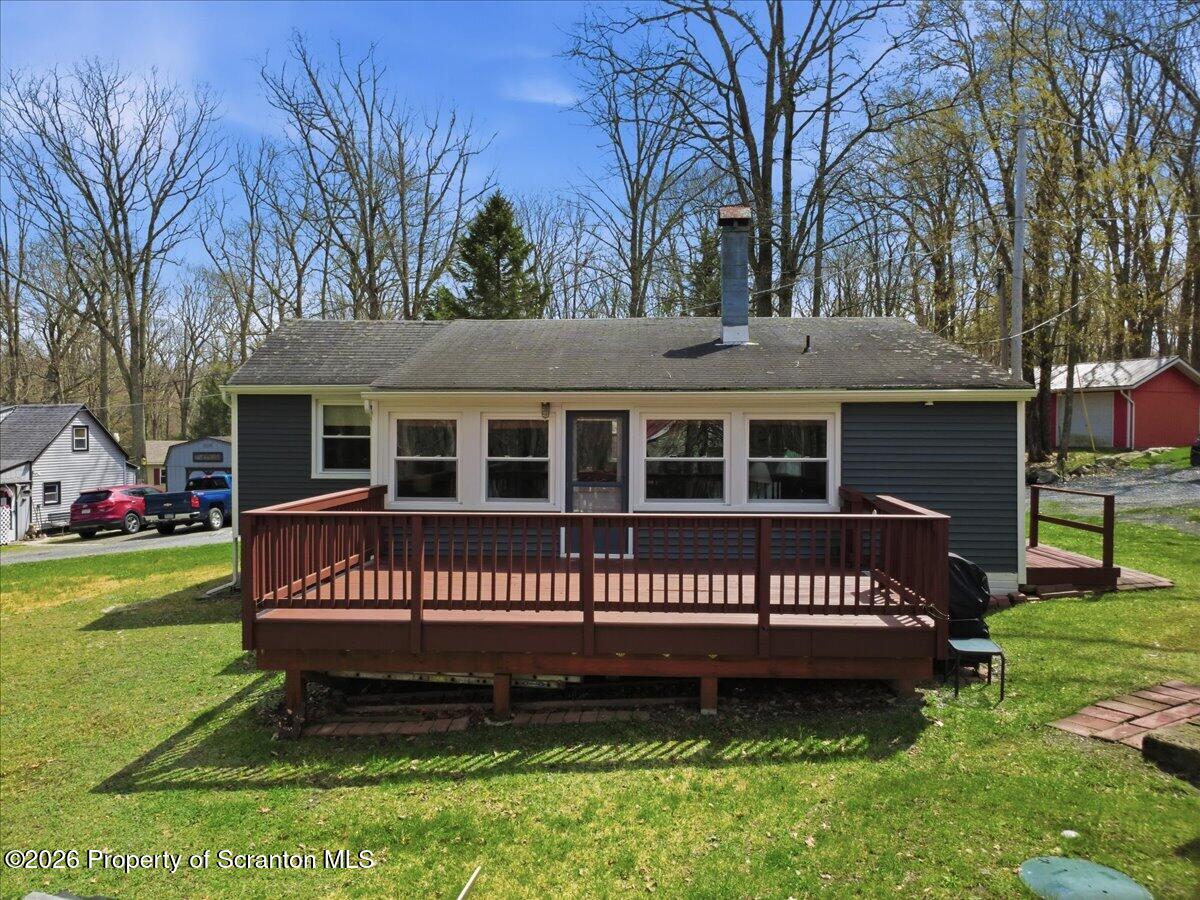 113 Stoney Hill Road Dingmans Ferry, PA 18328 - Photo 37 of 65 a view of a house with a yard and a bench