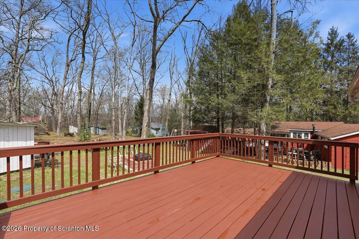 113 Stoney Hill Road Dingmans Ferry, PA 18328 - Photo 38 of 65 a view of a balcony with wooden floor and fence