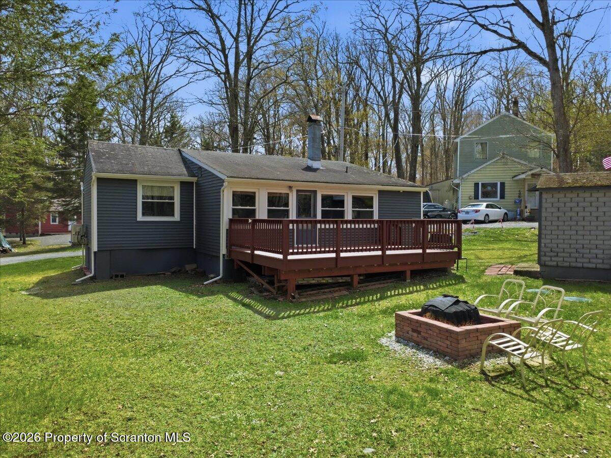 113 Stoney Hill Road Dingmans Ferry, PA 18328 - Photo 42 of 65 a view of a house with backyard and sitting area