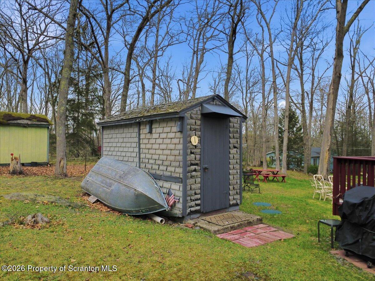 113 Stoney Hill Road Dingmans Ferry, PA 18328 - Photo 47 of 65 a backyard of a house with table and chairs