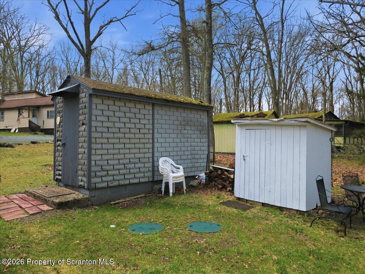113 Stoney Hill Road Dingmans Ferry, PA 18328 - Photo 53 of 65 a backyard of a house with table and chairs