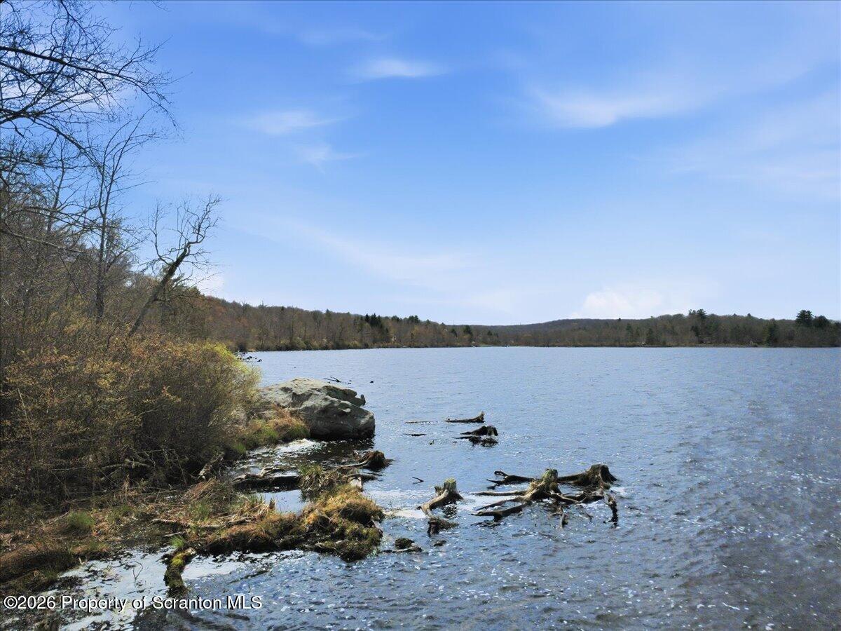 113 Stoney Hill Road Dingmans Ferry, PA 18328 - Photo 56 of 65 a view of a lake with a mountain