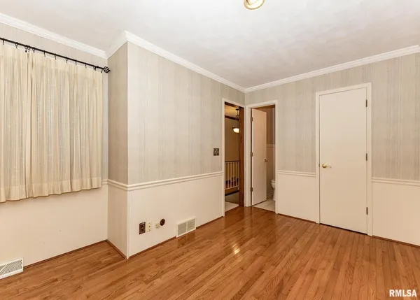 a view of a room with wooden floor