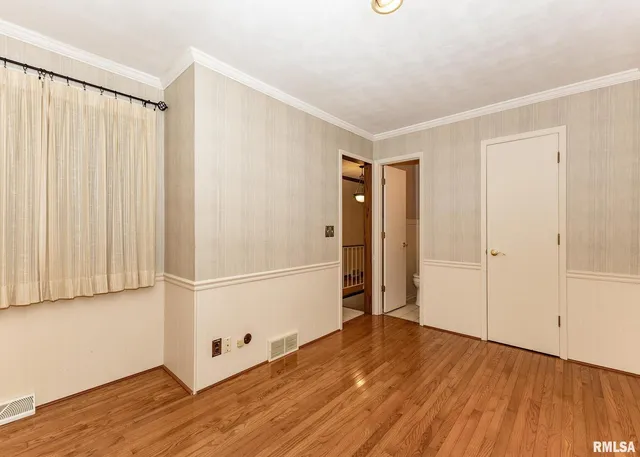 a view of a room with wooden floor