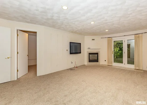 a view of a livingroom with an empty space and a fireplace