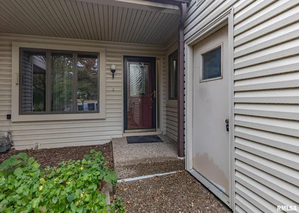 a view of front door and porch with seating space