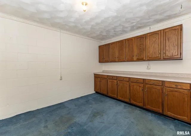 a kitchen with granite countertop white cabinets and sink