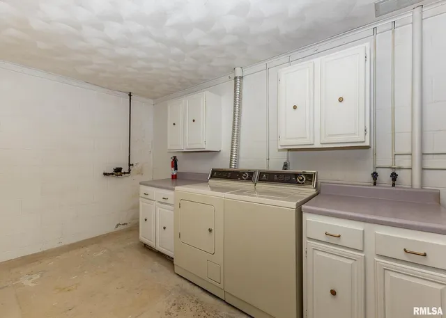a view of a storage and utility room with cabinets