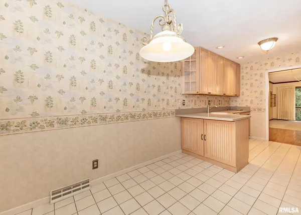 a kitchen with a sink window and cabinets