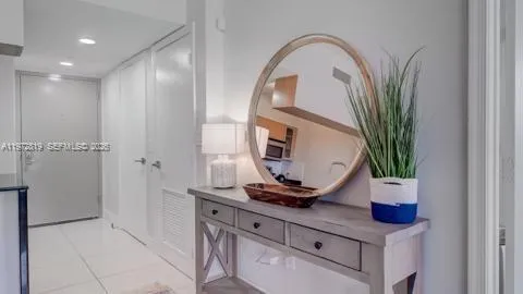 a view of living room with a front door and potted plant