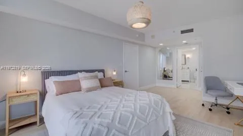a bedroom with a bed and a chair