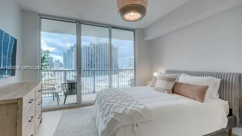 a bedroom with a large bed and a large window
