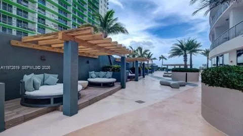 a view of a patio with couches and a fire pit