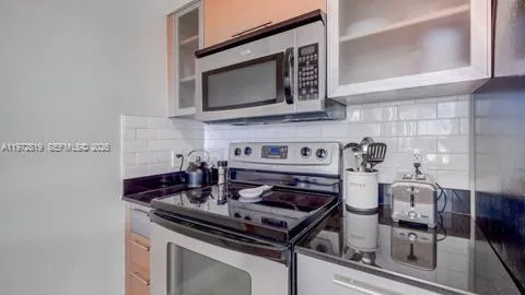 a stove top oven sitting inside of a kitchen